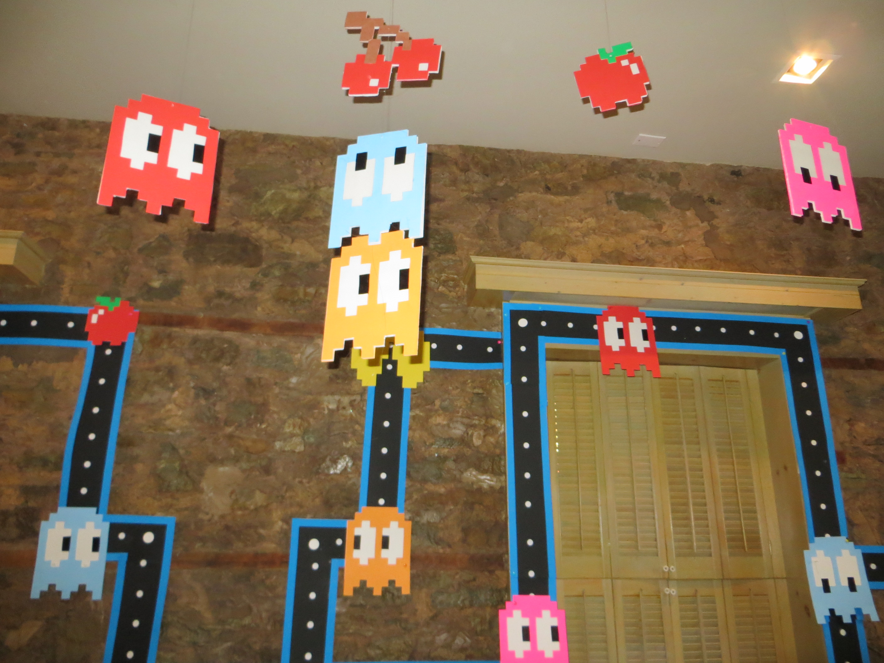 Elaborate Pac-Man theme decorations at birthday party.
