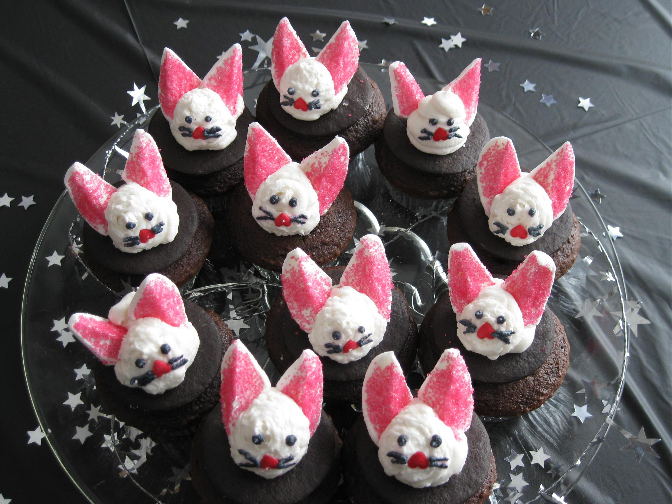 Cupcakes with cute marshmallow bunnies on top.