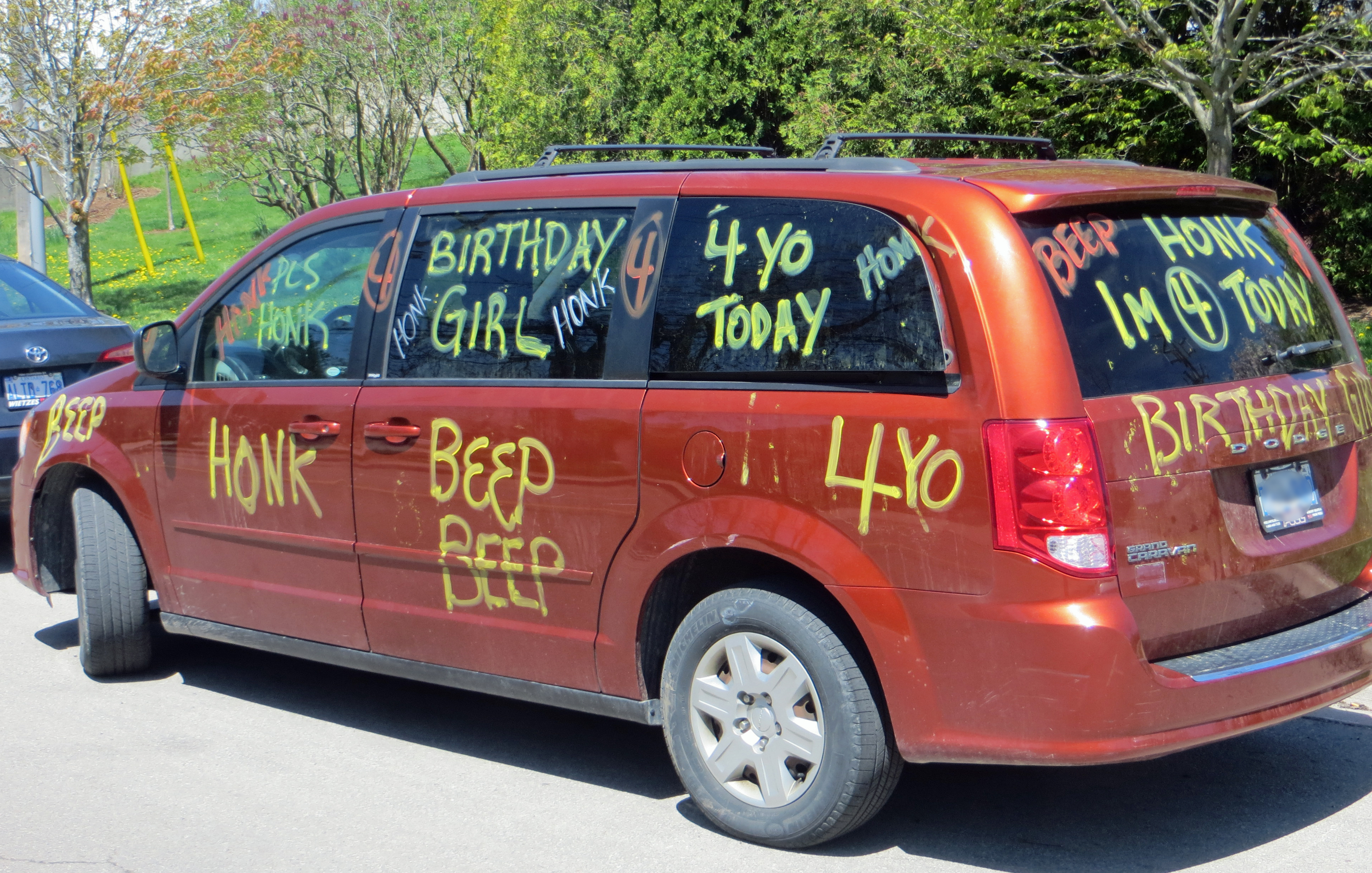 Mini van with birthday greetings painted all over exterior.