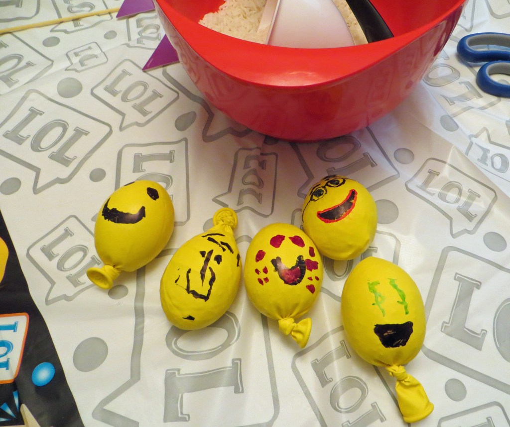 Emoji theme balloon balls made by kids as crafting activity at birthday party.