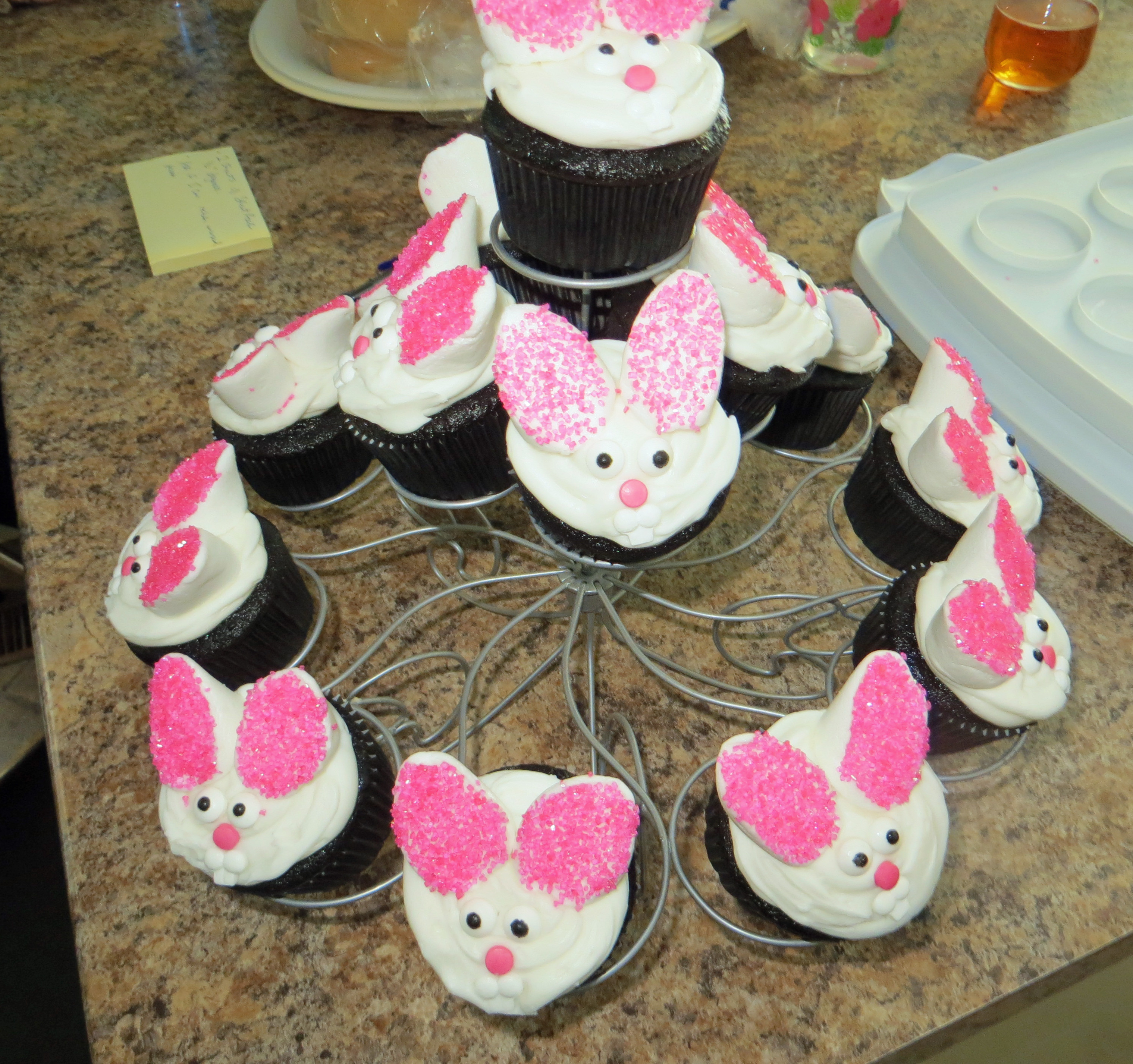 Display stand filled with bunny cupcakes.