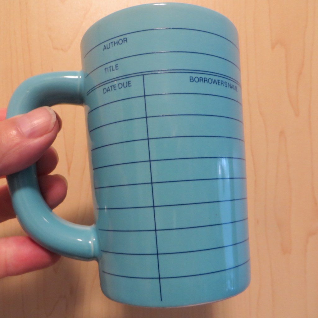 Light blue mug decorated with retro library book borrowers record card theme design.