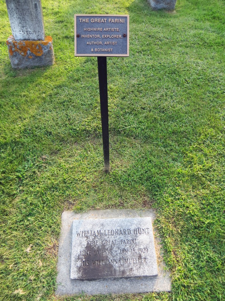 Farini grave has flat stone marker and small historic plaque on pole.