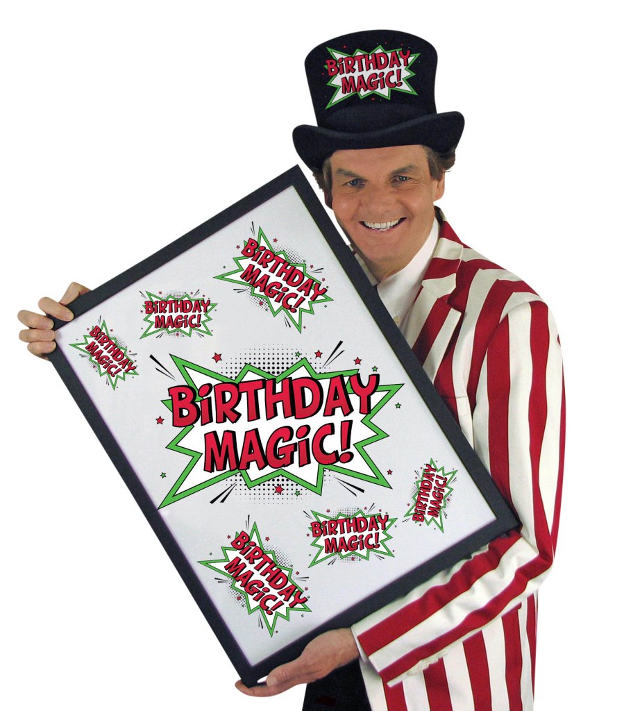 Magician Owen holding a sign with the words Birthday Magic plastered all over it.