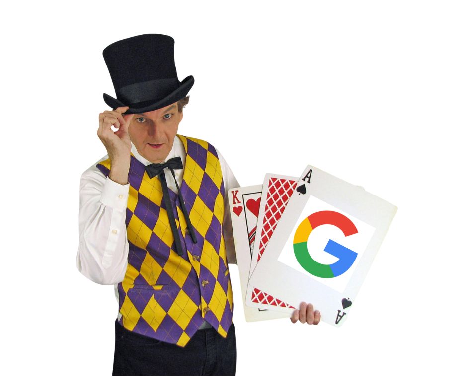Owen dressed like a riverboat gambler holding 3 oversize playing cards. The Ace has the the Google logo on it.