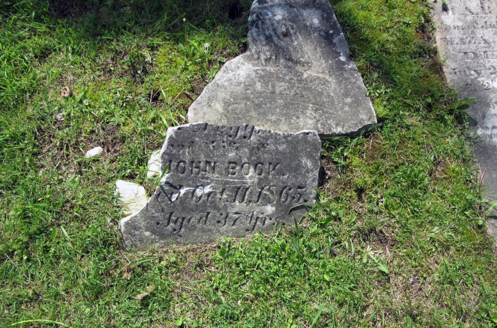 Broken memorial marker of John Book.