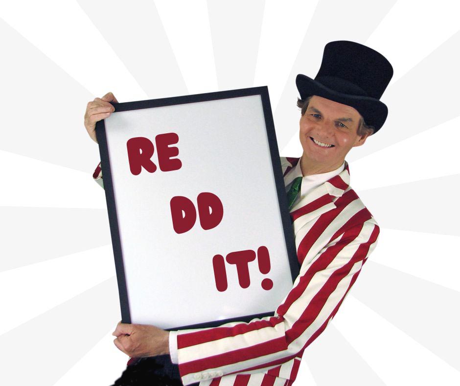 Owen the Magician holding a large whiteboard with the word Reddit written on it.