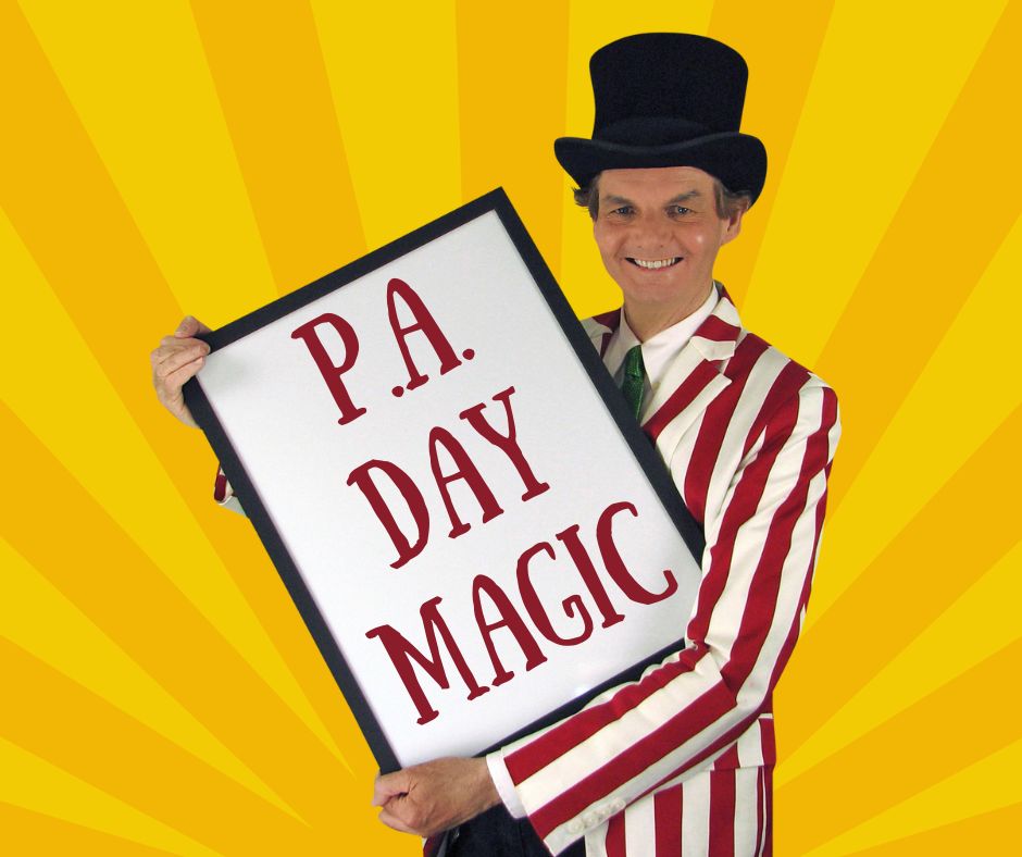 Magician Owen holding a sign that reads PA Day Magic.