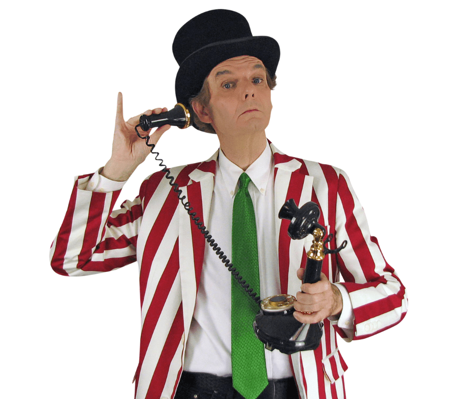 Magician Owen in costume wearing top hat and holding old fashioned candlestick telephone.