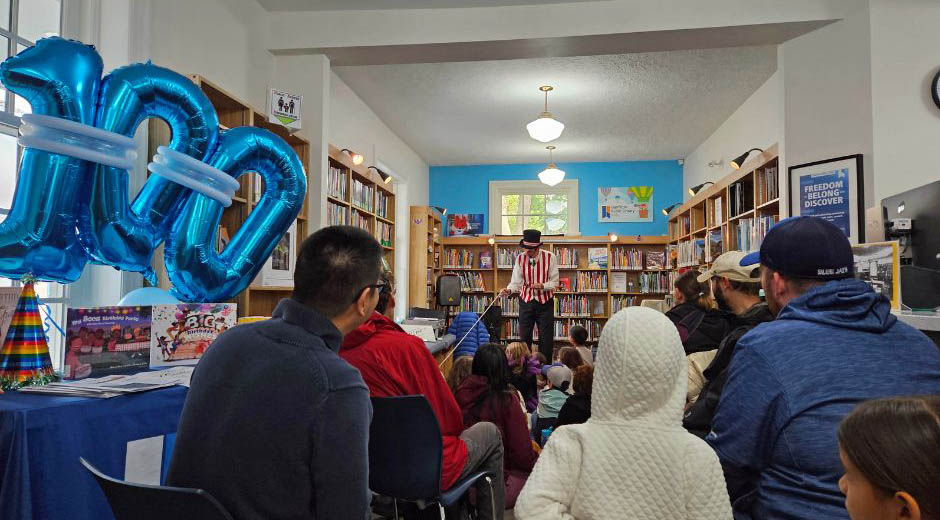 Owen performing in front of crowd at Locke Street Library during their 100th birthday party.