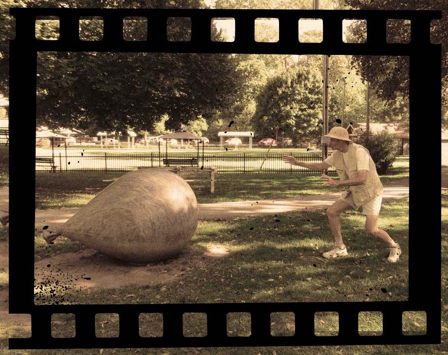 Gag photo of Owen dressed in safari clothes approaching granite balloon sculpture.
Edited to look like a frame from an old movie.