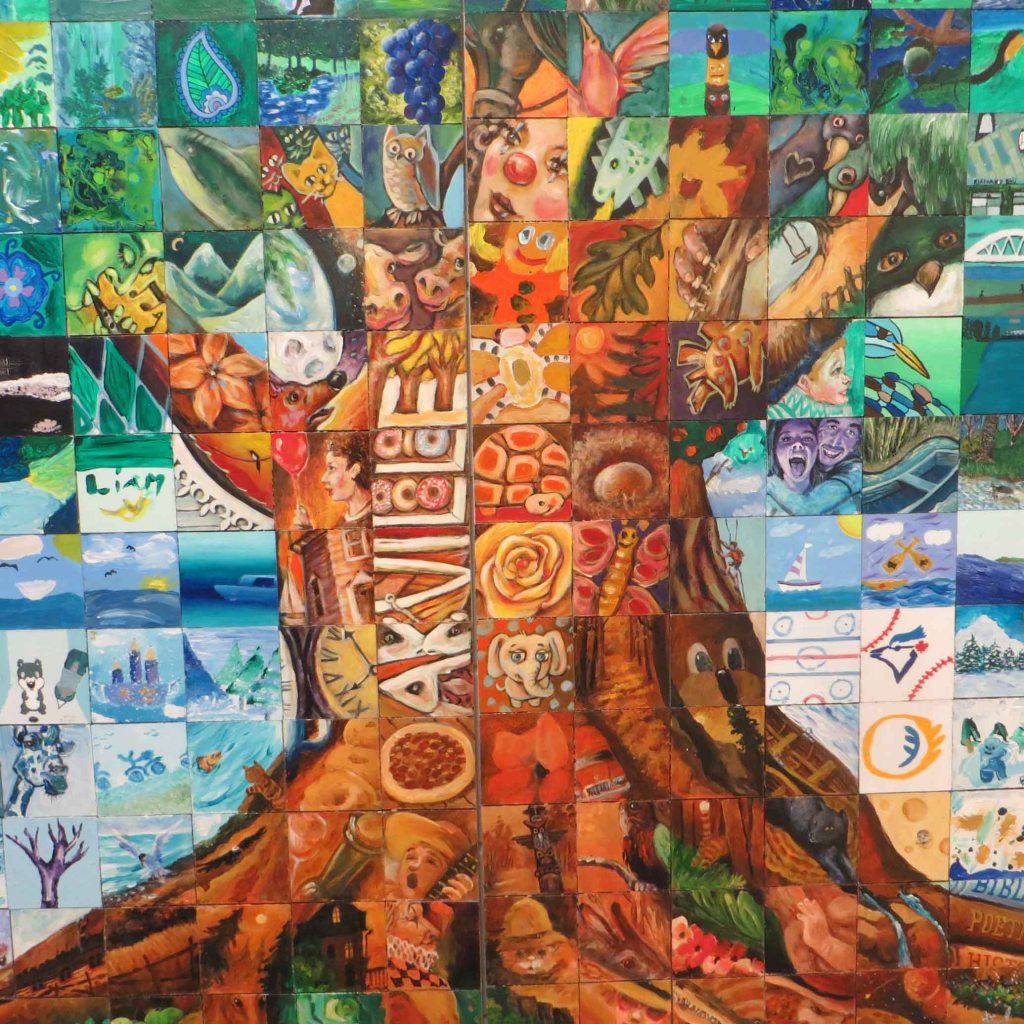 Mosaic style wall mural. The many small square images together form an oak tree. Town name Oakville is prominent in tree trunk.